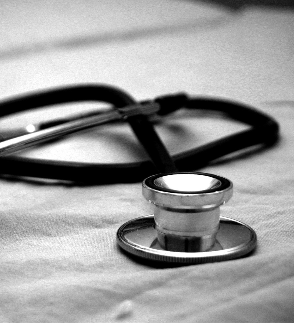 A stethoscope resting on a bed linen