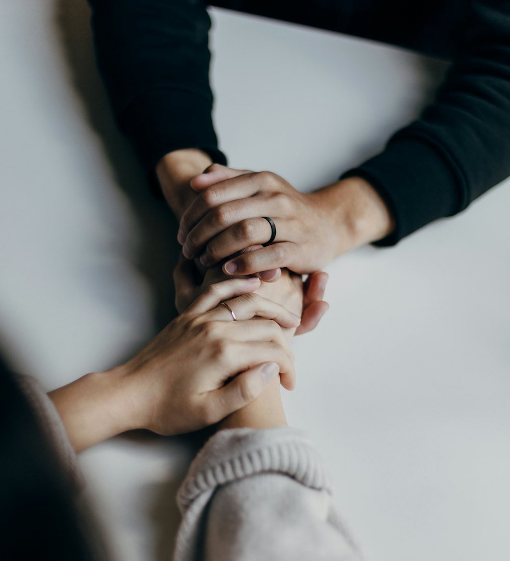 Two people holding hands in a moment of support